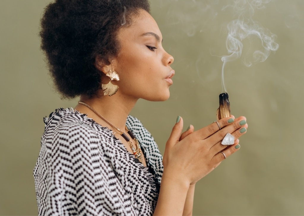 woman burns palo santo